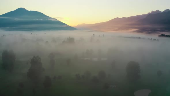 Drone Over Ethereal Misty Landscape Of Zell Am See At Sunrise