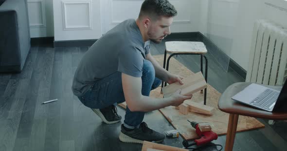 Man is Building Furniture Himself Making Renovation at Home