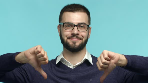 Close Up of Skeptical Male Boss in Glasses Shaking Head with Disapproval Showing Thumbs Down and