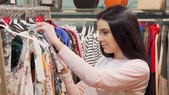 Woman Looking Shocked By the Price of a Dress at Clothing Store