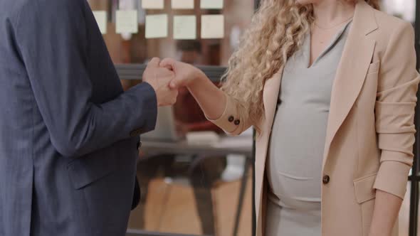 Colleague Shaking Hands with Pregnant Woman