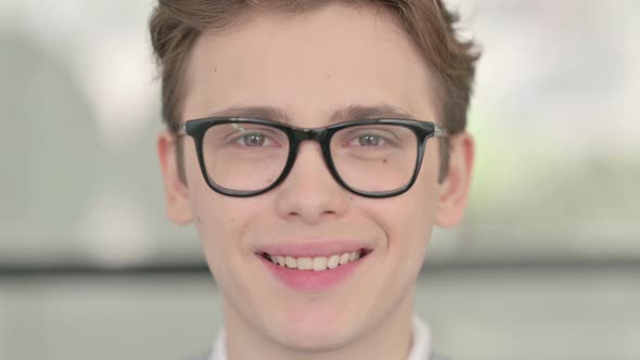 Close Up of Young Man Smiling at the Camera