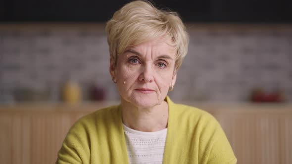 Serious Retiree Lady is Looking at Camera Emotional Portrait of Old Woman in Apartment Online Video