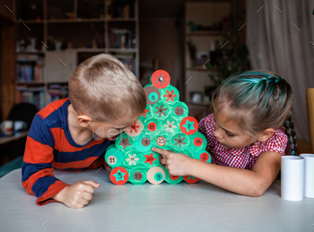 Kids making handmade advent calendar with toilet paper rolls at home. Seasonal activity for kids / Photodune, Misc