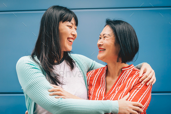 Asian mother and daughter embracing outdoor - Happy Chinese family enjoying time outside / Photodune, Misc