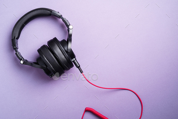 Classic black wired headphones on violet minimal background / Photodune, Misc