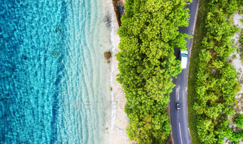 Aerial view on road in the forest. Highway through  the forest and sea coast. View from a drone. / Photodune, Misc