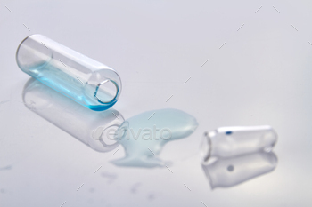 Empty medical vial on white reflective surface. / Photodune, Misc