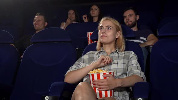 Young Attractive Woman Smiling Showing Thumbs Up at the Cinema