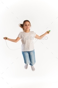 Cheerful girl in casual clothes jumping on rope / Photodune, Misc