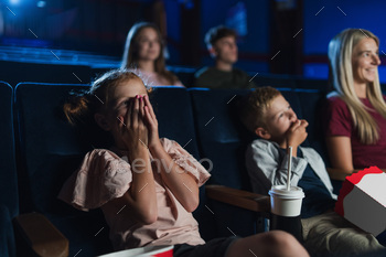 Mother with small children in the cinema, watching film / Photodune, Misc