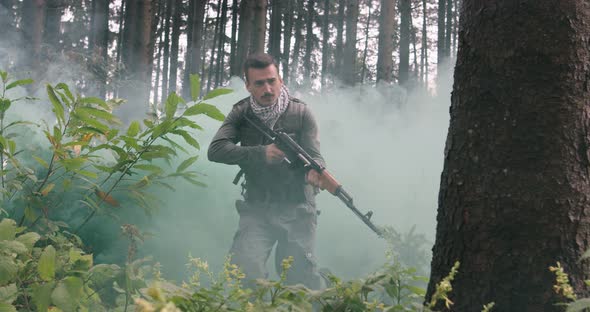 Terrorists Running Thorugh Dense Forest with Smoke or Haze in Backgorund Terrorist in Dangerous