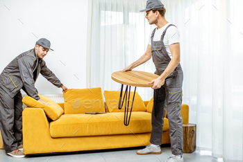 Movers placing furniture at home / Photodune, Misc