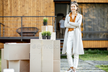 Woman with boxes in front of a new house / Photodune, Misc