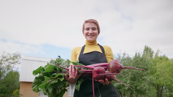 Woman Farmer Holding Fresh Vegetables