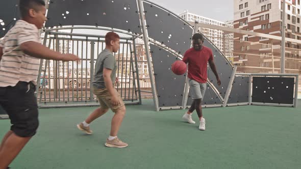 Dad with Sons Playing Basketball Outdoors