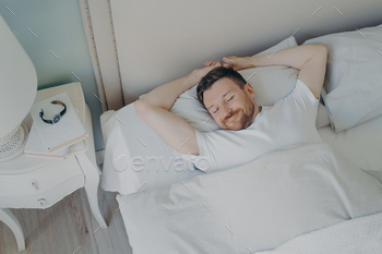 Young happy relaxed caucasian man sleeping in bed / Photodune, Misc
