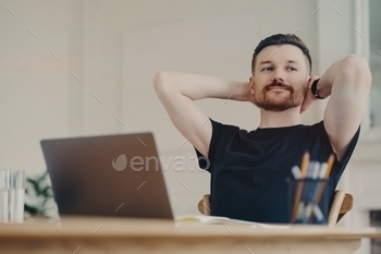 Happy business person resting after work while sitting at his workplace at home / Photodune, Misc