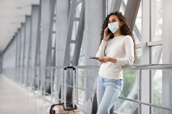 Young Middle Eastern Woman In Medical Mask Talking On Cellphone In Airport / Photodune, Misc