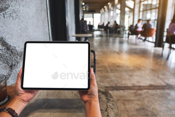 Mockup image of a woman holding digital tablet with blank white desktop screen / Photodune, Misc