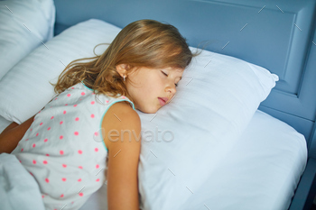 Little girl sleeping on a big and cozy bed white linen in the afternoon at home / Photodune, Misc