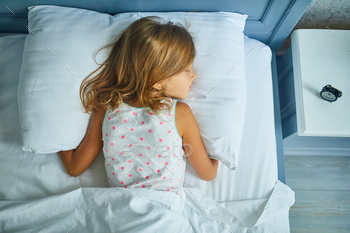 Little girl sleeping on a big and cozy bed white linen in the afternoon at home / Photodune, Misc