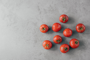Fresh red tomatoes with water drops isolated over grey background with copy space / Photodune, Misc