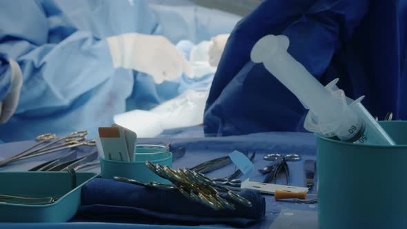 Surgeons working during open heart surgery, close up on hands and instruments.