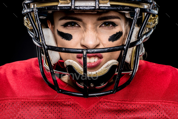 Close-up portrait of female american football player in sportswear and helmet on black / Photodune, Misc