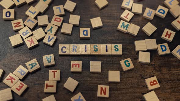 Crisis Word Gathered From Wooden Block Letters  Conceptual Zoom in Shot