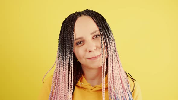 Young Woman with Senegalese Pigtails Looking at Camera