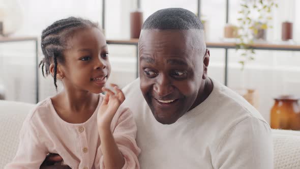 Portrait of Little African Girl Child Daughter Toddler Preschooler Sitting with Adult Man Mature