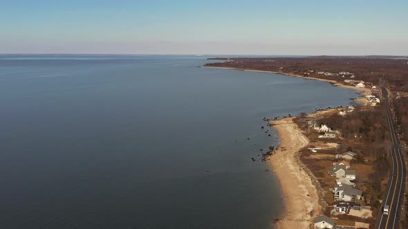 an aerial shot, looking down along an empty beach while it was quiet and peaceful on a sunny afterno