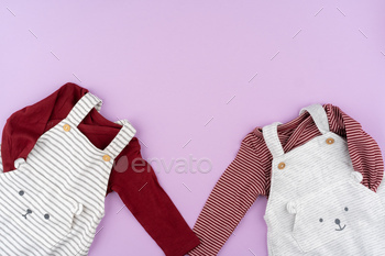 Baby girl clothes on lilac pastel background / Photodune, Misc