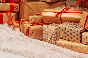 Stack of christmas gifts on beige carpet / Photodune, Misc