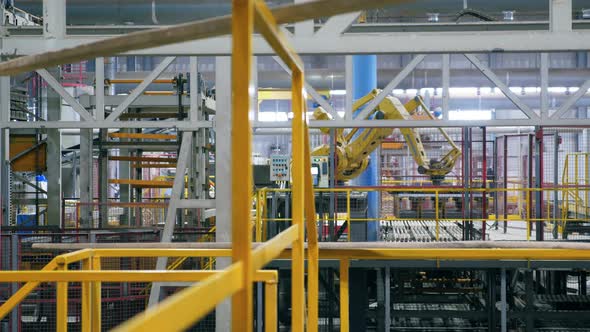 Robotic Arm Moving Many Bricks at a Plant.