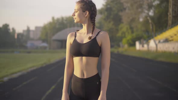 Camera Approaches To Confident Sportswoman Turning To Camera. Portrait of Beautiful Slim Caucasian