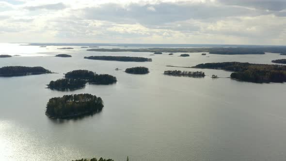 Aerial, tracking, drone shot, panning over islands, in the archipelago of Porvoo, on the Gulf of Fin