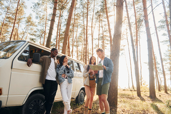 Group of young people is traveling together in the forest at daytime / Photodune, Misc