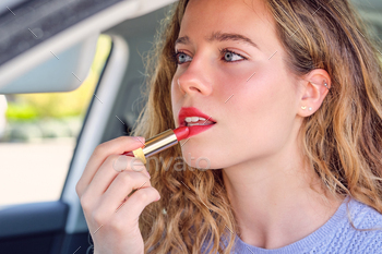 Crop gorgeous woman applying red lipstick in car / Photodune, Misc