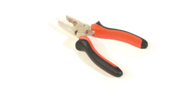 Gray and Red Pliers on White, Rotation