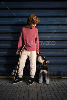 Little skater with dog resting on street / Photodune, Misc