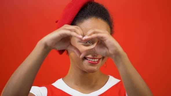 Smiling Woman Making Heart With Hands, Kindness, Charity Work, Red Background