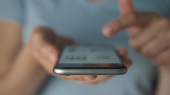 Young Woman Using Apps on a Mobile Touchscreen Smartphone