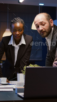 Diverse teamwork checking management presentation on laptop computer / Photodune, Misc