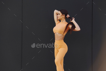 Yellow sportswear. Young woman have fitness session outdoors / Photodune, Misc
