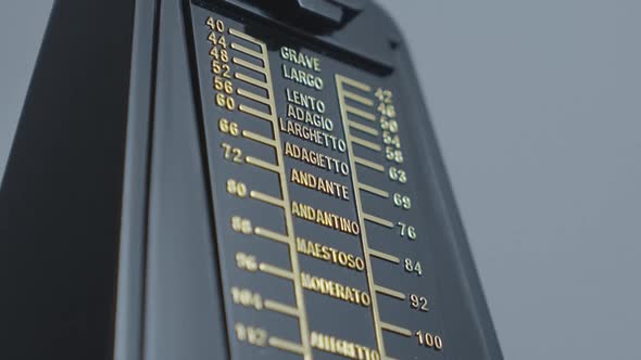 Old fashioned mechanical metronome showing music tempo.