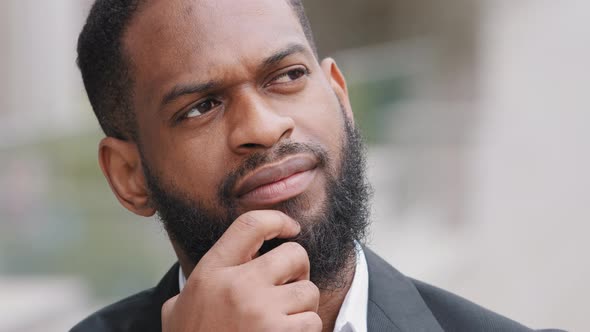 Serious Bearded African American Businessman Wearing Suit Standing Outdoors Thinking of Business