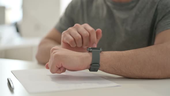 Hands of Young Man Using Smartwatch Close Up