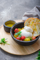 Buratta cheese with cherry tomatoes, basil and olive oil on black plate with crusty bread. Copy - PhotoDune Item for Sale
